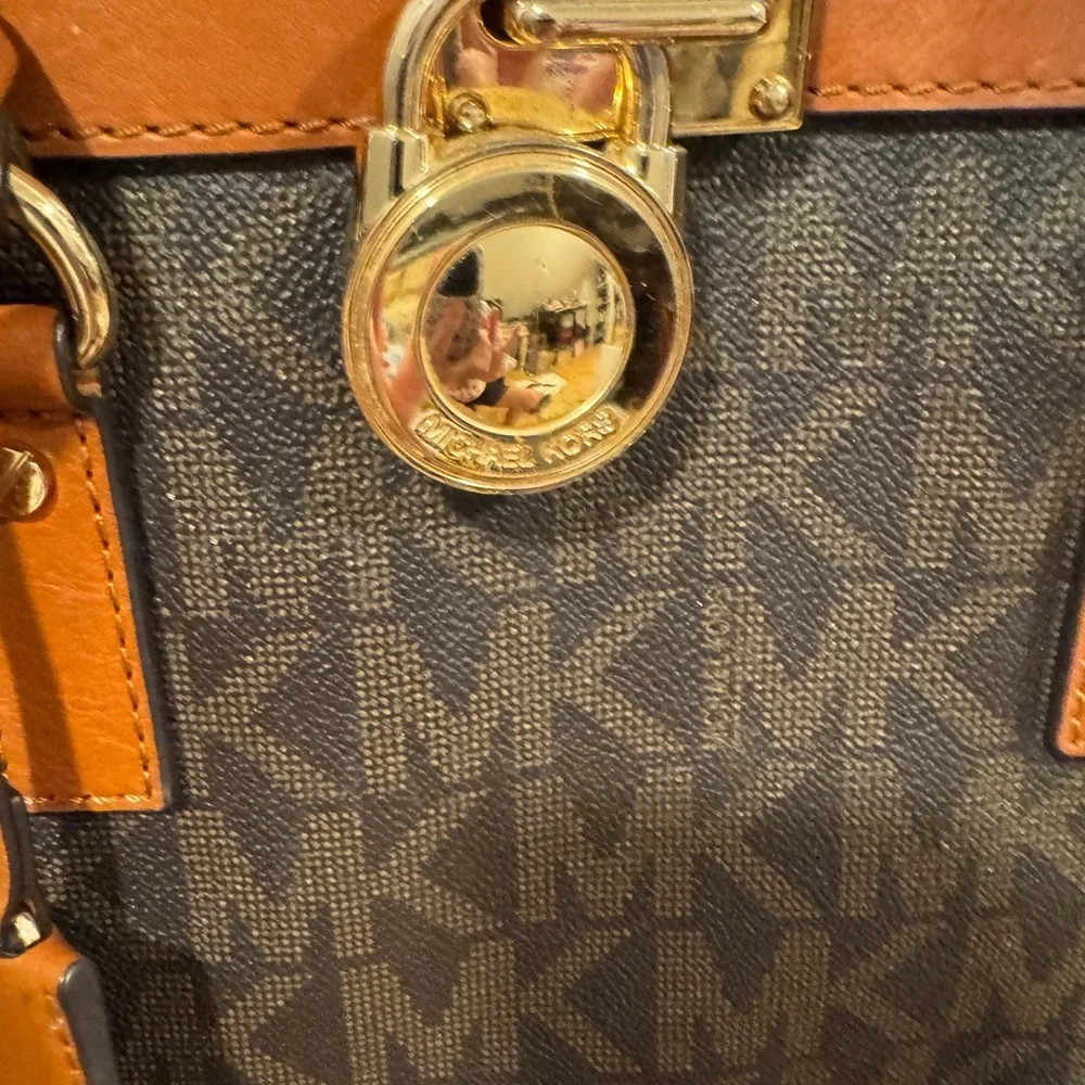 Michael Kors Emblemed satchel style purse. Strap has some gold chain and leather